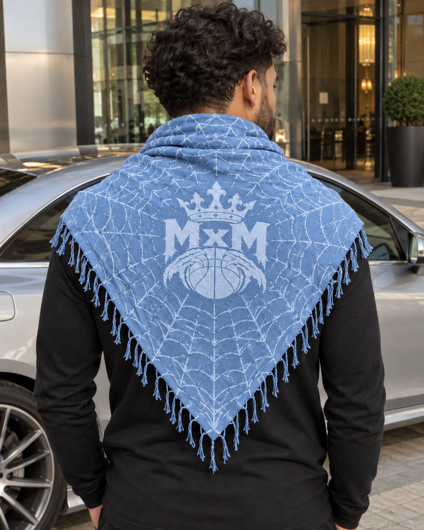 Light Blue MxM keffaya back MxM logo exact brown template, unique model beside silver coupe at modern steel and glass hotel driveway