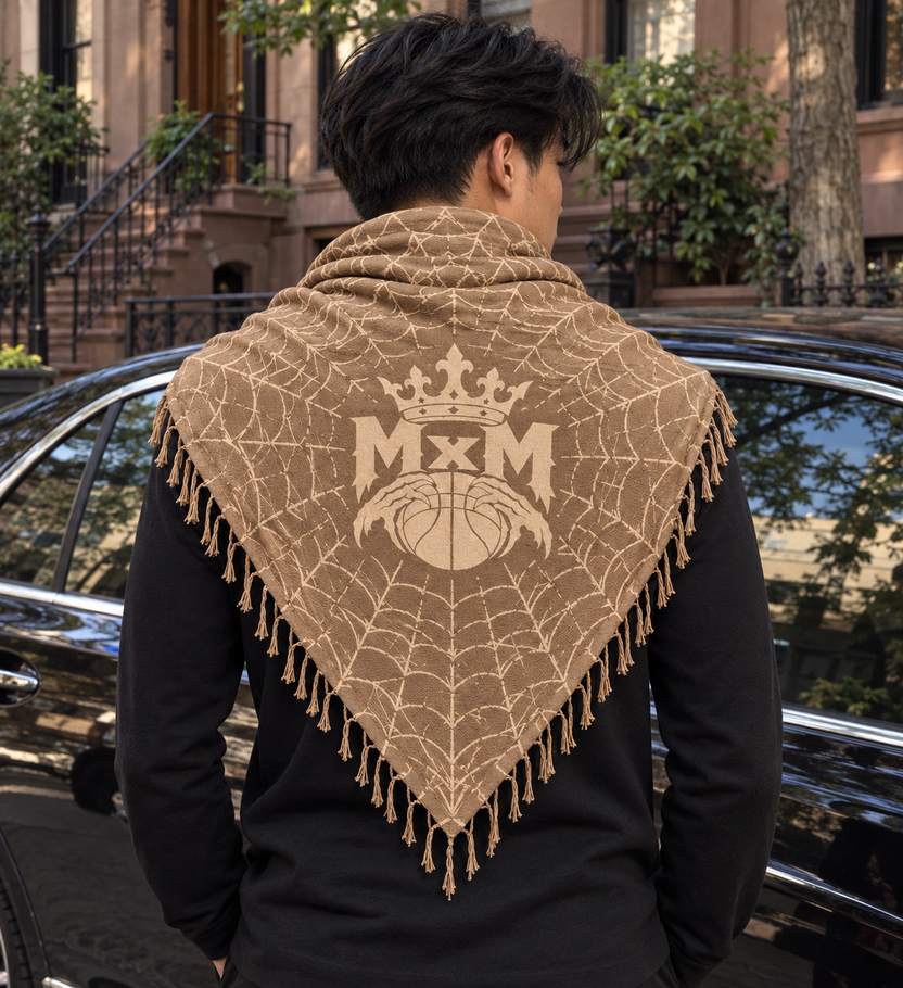 Tan MxM keffaya back MxM logo exact brown template, unique model beside dark luxury sedan on quiet brownstone street