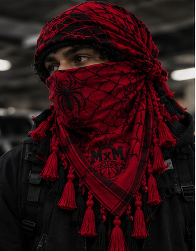 MxM spiderweb keffiyeh red model styling concept: face spider, crowned MxM basketball logo, triangular web pattern and knotted tassel fringe. Digitally rendered, not a manufactured sample photo.