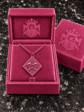 Pink MxM diamond-face necklace with matching pink eyes, chain, and MxM logo box