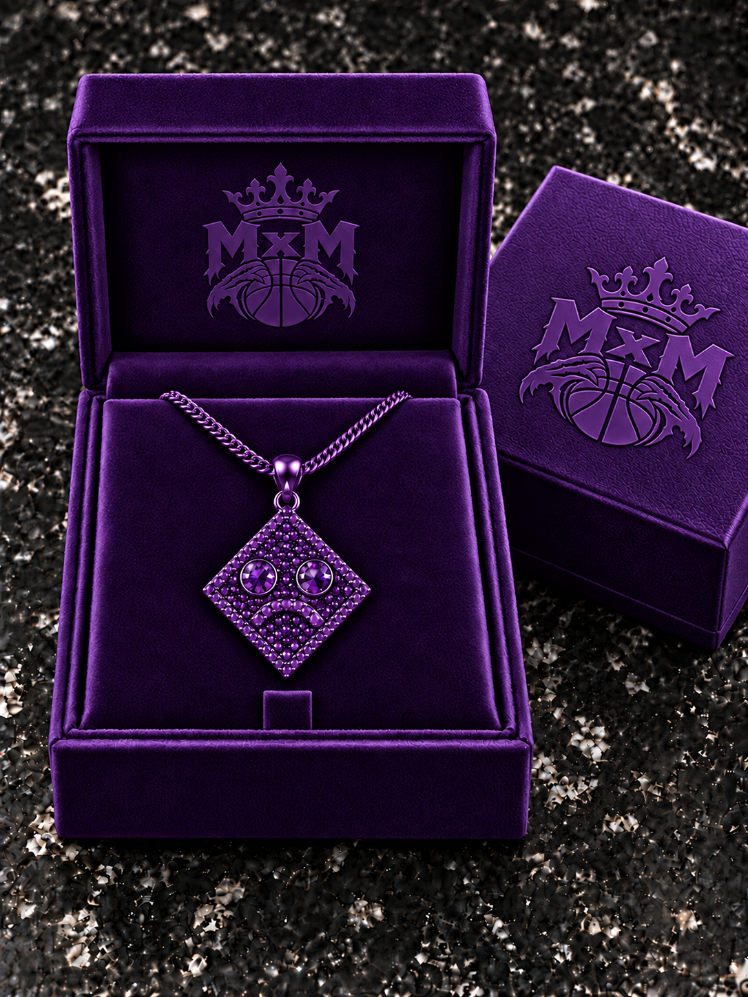 Purple MxM sad-face necklace in matching velvet box with crests inside and outside