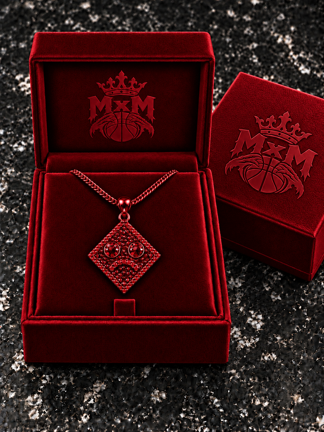 Red MxM sad-face necklace in matching velvet box with crests inside and outside
